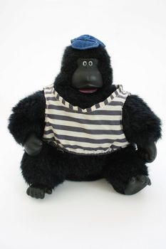 dressed stuffed toy gorilla wearing shirt and hat 
