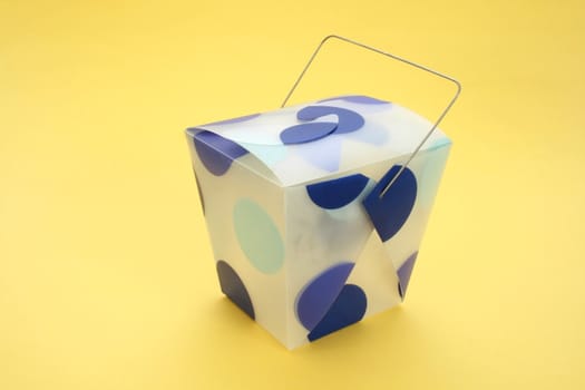 blue dotted oriental carton isolated on yellow background
