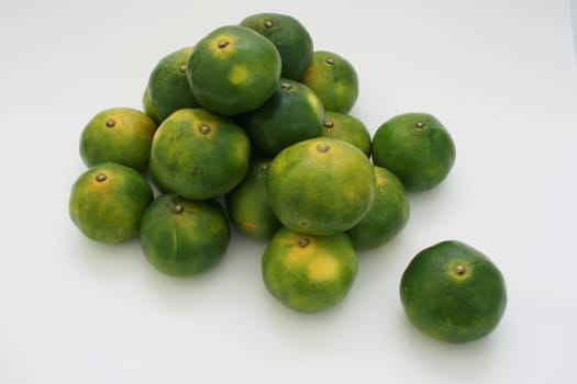 a bunch of oriental green citrus fruit
