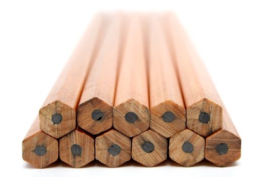 Pile of wooden pencils for plotting on a white background