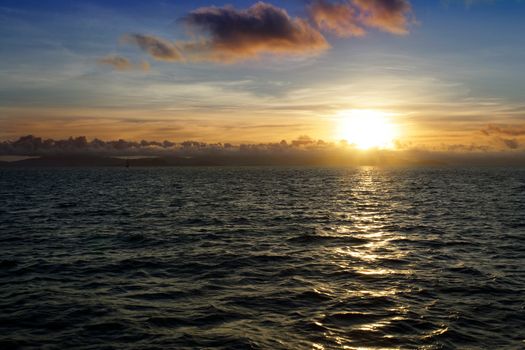 A beautiful sunset in the Whitsundays - off the east coast of Australia.  Taken from the deck of an old wooden ship cruising past some islands.
