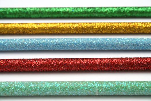 Five celebratory color pencils with a multi-coloured sparkling covering detailed