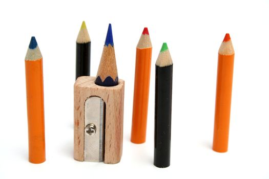 The set of small color pencils around of a unusual sharpener which stands vertically