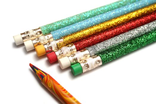 Set of celebratory pencils about a multi-colour pencil on a diagonal