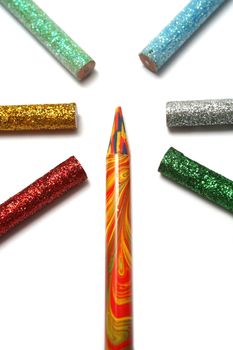 The multi-colour pencil is surrounded by brilliant color pencils from above