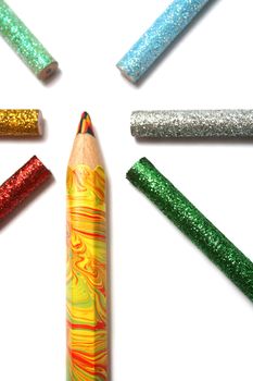 The multi-colour big pencil is surrounded by brilliant color pencils from above