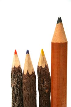 Three unusual pencils made of natural wood and one simple huge pencil vertical