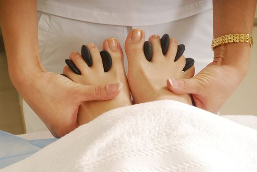 Dark gray stones in the woman feet