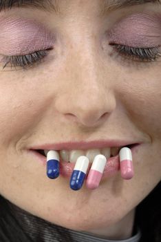 Young woman's strange face with pills