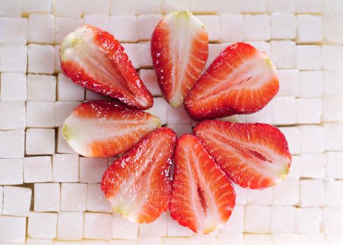 White sugar cubes background with strawberry 