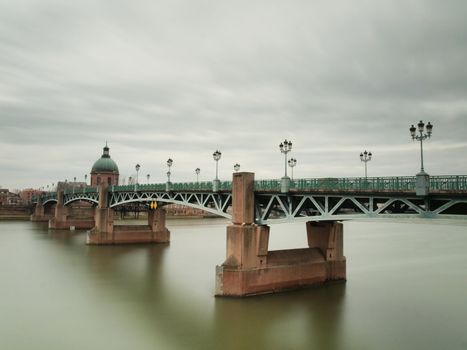 Pont Saint Pierre bridge over the garonne in the city of Toulouse in France under overcast sky