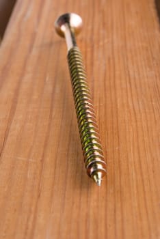 Screw on a wooden background