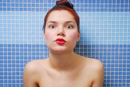 Woman with surprised look on a blue background