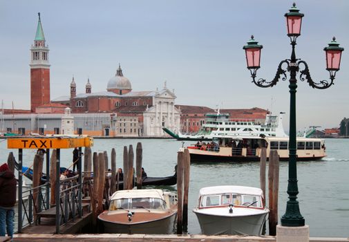 Taxi boats, gondola, vaporetto and ferry boat in front of San Giogio Maggiore Island, Venice, Italy