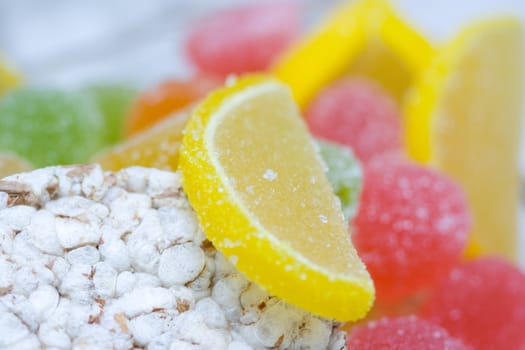 small loaf of bread and heap of colorful dried sugared fruits