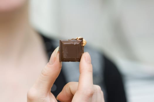 chocolate pieces in woman's hands