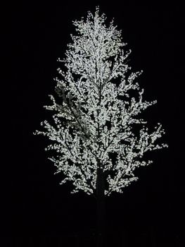 Artificial tree with white bulbs on branches