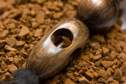 aromatic instant coffee and wooden decoration with amber macro