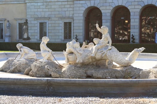 The fountain in Villa Olmo's gardens in Como, Italy, showing some children playing with a sea monster. Villa Olmo was built between 1782 and 1796 and it was inaugurated by Napoleon in 1797