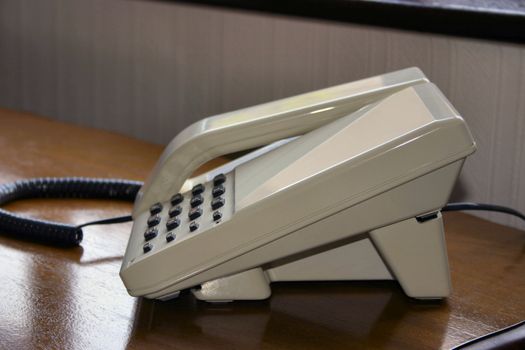 beige telephone on a table