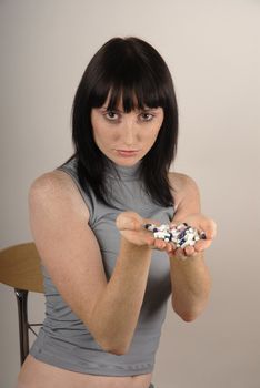 Young woman offer colours pills