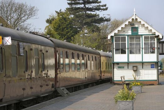 old railway carriages and signal box at a railway station