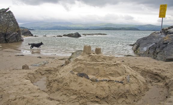 Sandcastle on sea edge.