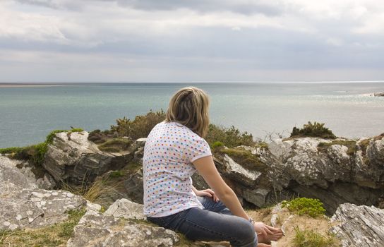 Pretty girl looks out to sea.