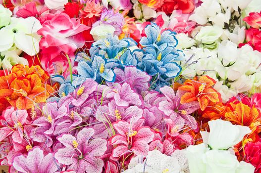 Various brightly colored artificial flowers for sale at Flea Market