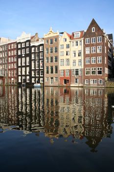 Amsterdam canal houses reflected in the water