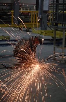 Welding operator on the floor and sparks 3