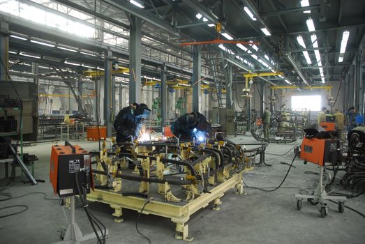 welding operators are working on factory
