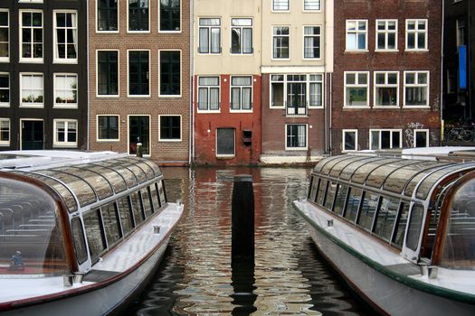 Tourboats in a canal in Amsterdam