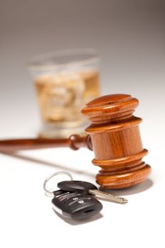 Gavel, Alcoholic Drink & Car Keys on a Gradated Background - Drinking and Driving Concept.