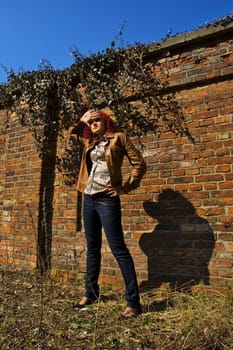 Beautiful young women over bricked wall