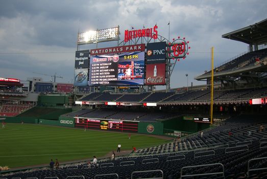 Batting practice before an early spring Nats baseball game, featuring huge scoreboard.