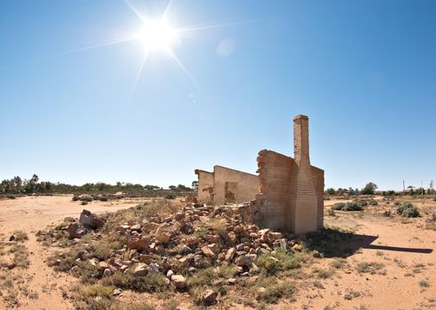 old rubble and ruins of a stone building in the hot sun of the desert