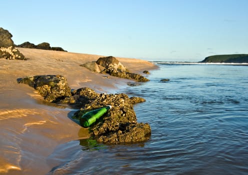 an sos message in a bottle at the beach