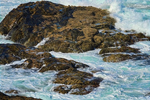 great image of strong waves splashing into the rocks