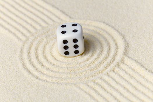 Composition on Zen garden - yellow sand, and dice