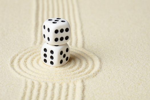 Composition on Zen garden - yellow sand, and two dice
