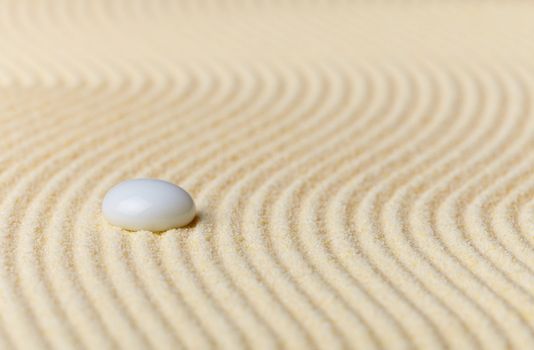Composition on Zen garden - yellow sand, and glass drop