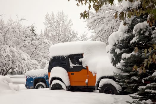 early morning driveway scene in Fort Collins, Colorado - cars after heavy November snow storm