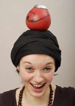 Young pretty woman with calabash on her head