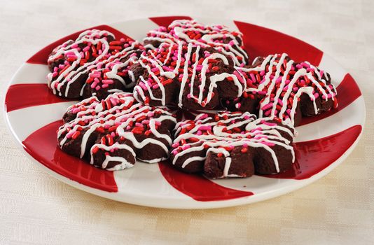 a plate of holiday cookies on a fancy plate