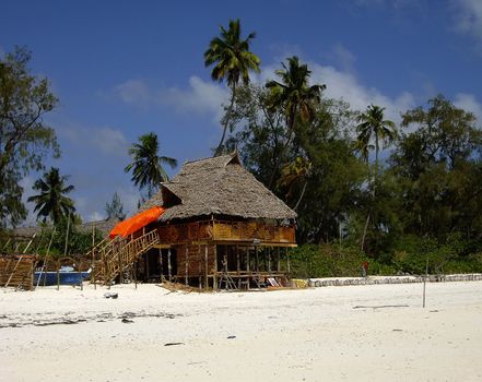 typical restaurant on the beach with Zanzibari roof of palm fronds