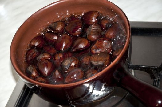 chestnuts put on a stove to boil water