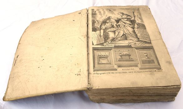           very old bible open on a white background                     
