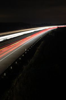 highway at night with car traffic and lights