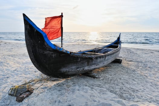 The old boat of fishermen on the sandy shore